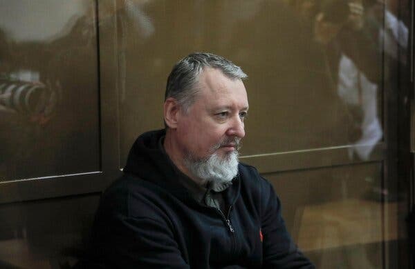 Igor Girkin sits behind glass.